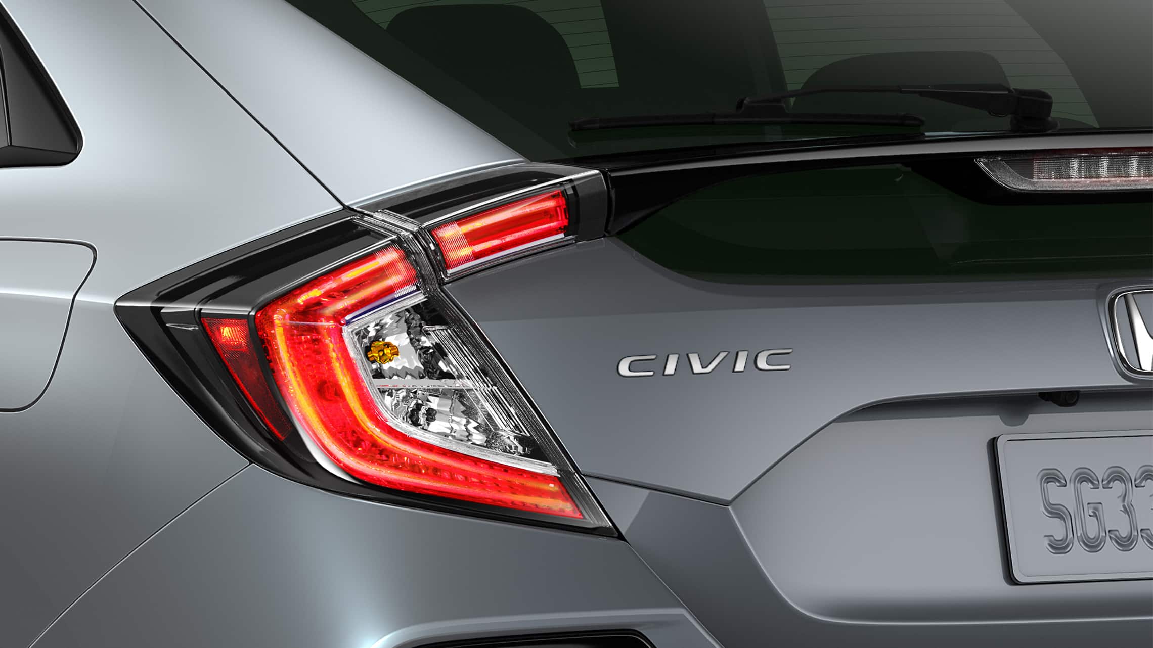 Detail of driver-side taillight on the 2021 Honda Civic Sport Touring Hatchback in Sonic Gray Pearl.