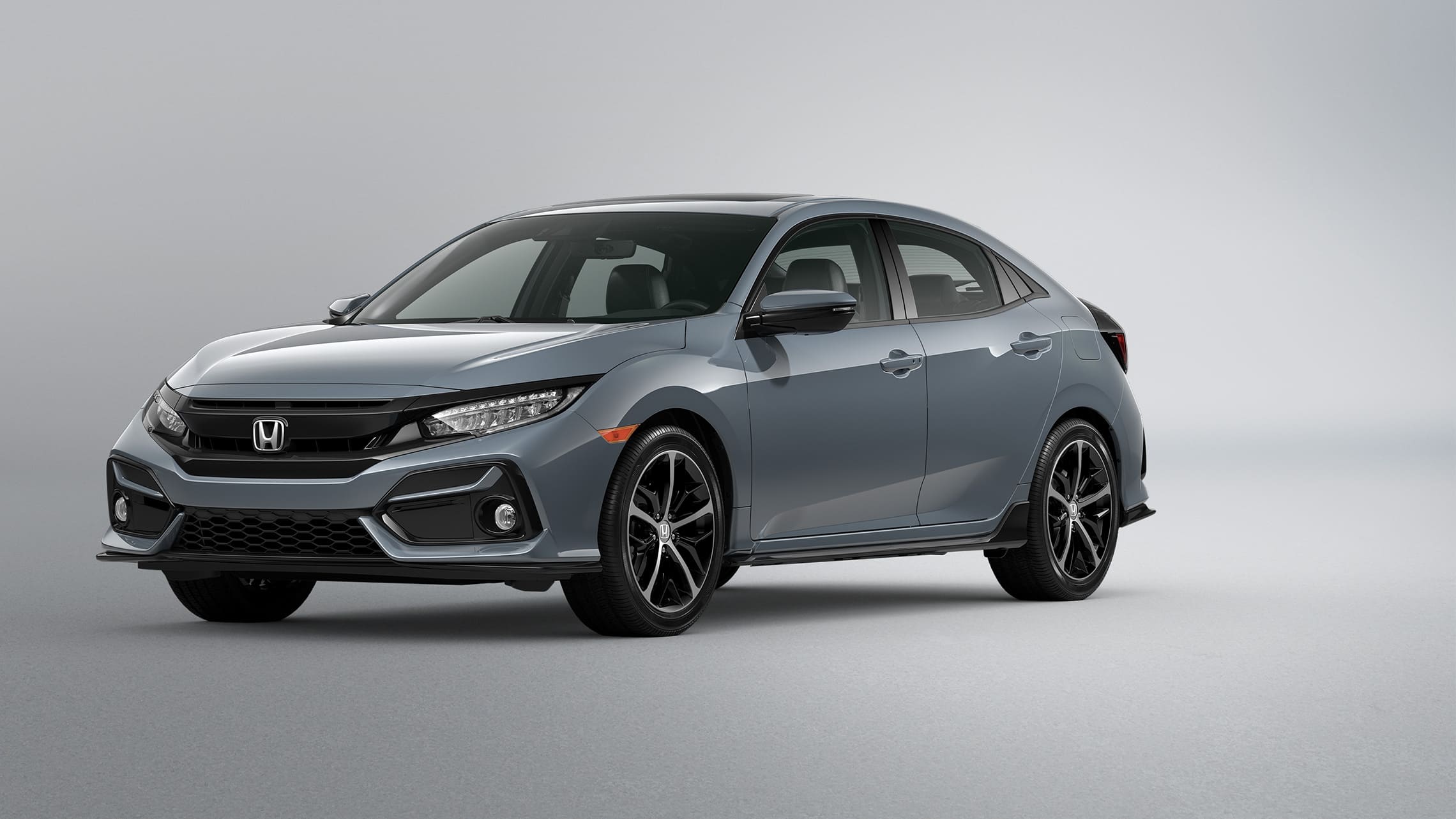Front driver-side view of the 2021 Honda Civic Sport Touring Hatchback in Sonic Gray Pearl.